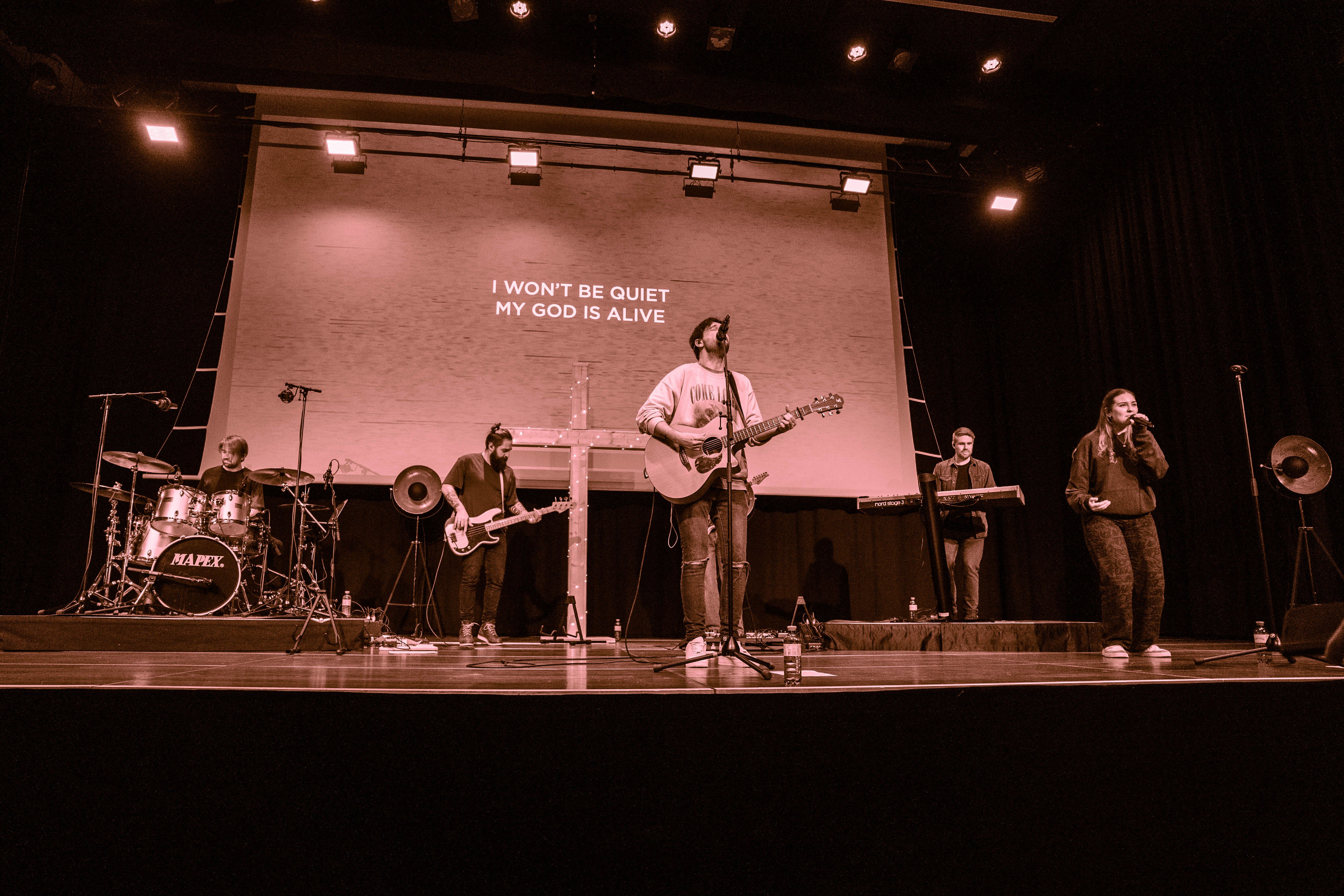 Catholic band playing modern church music on stage, upbeat praise
