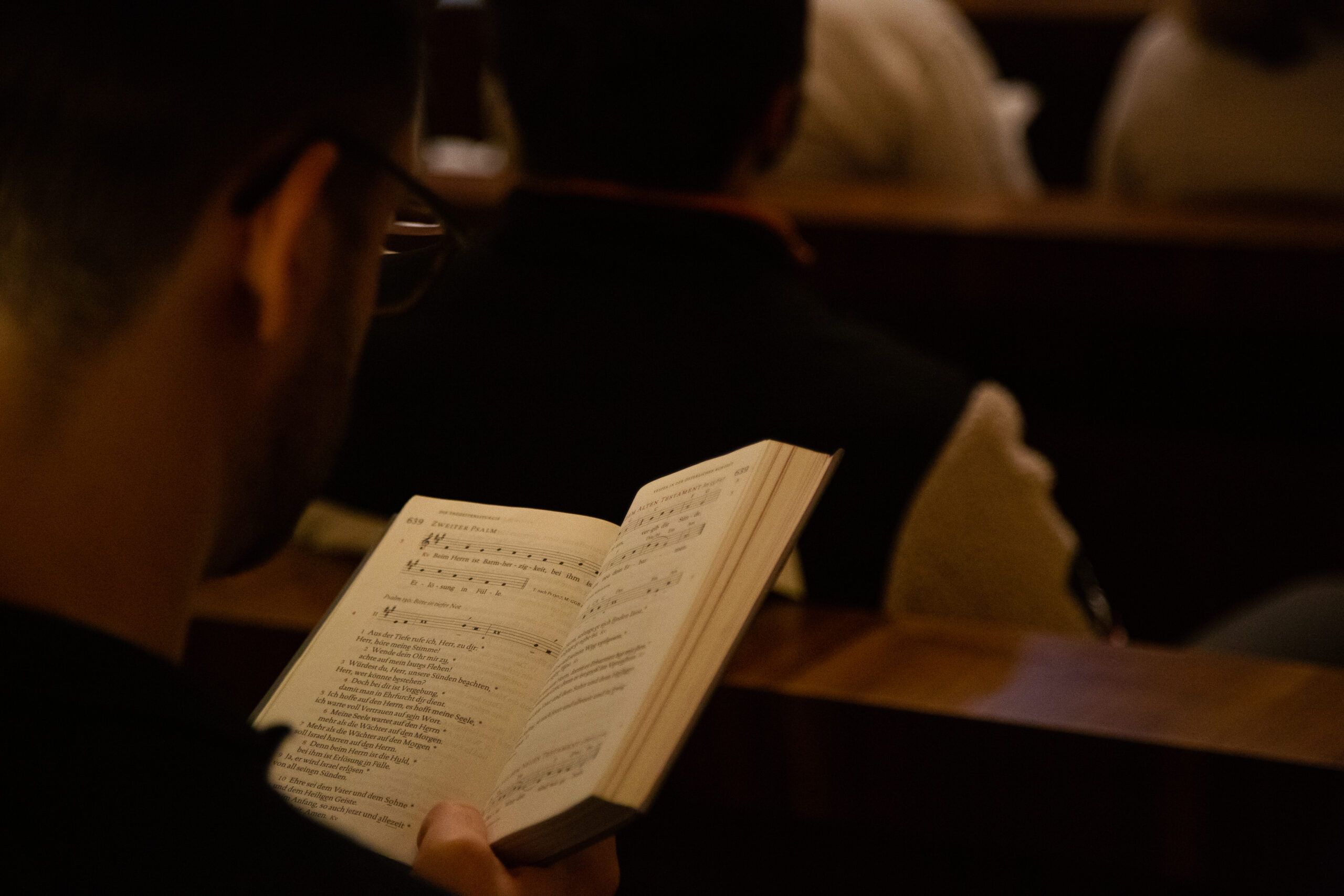 Lauds, Compline, young person singing and praying in church pew
